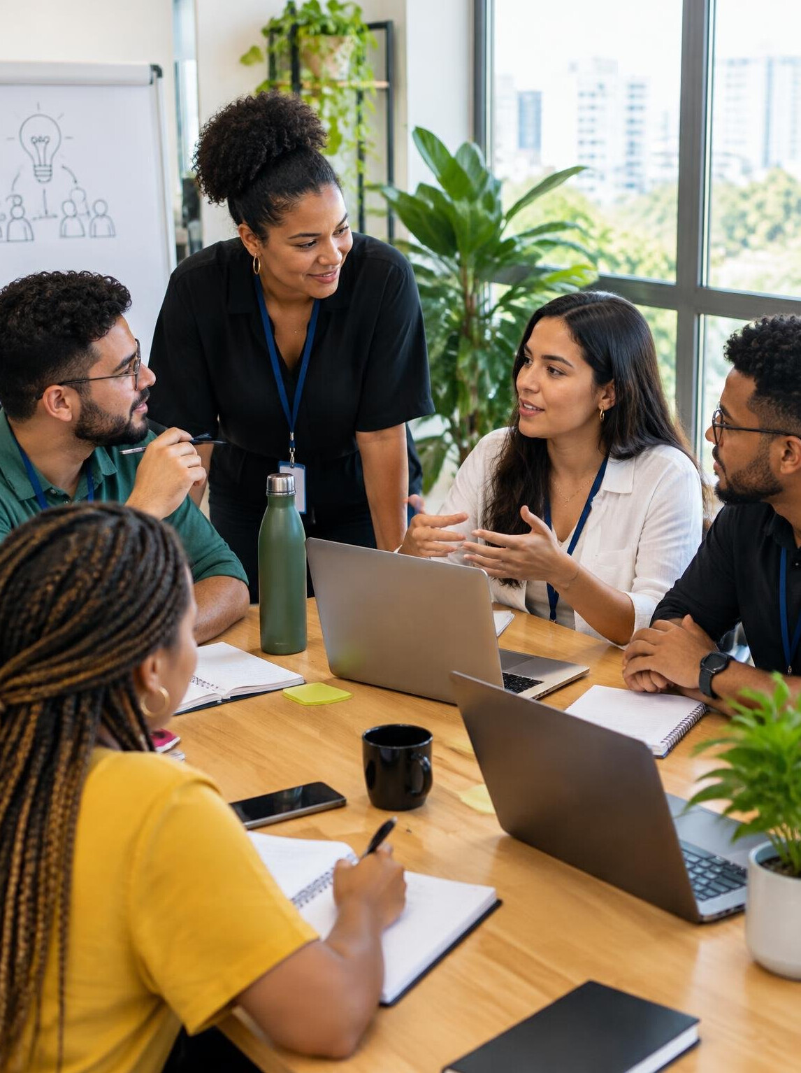 Team collaborating around a table during a leadership program